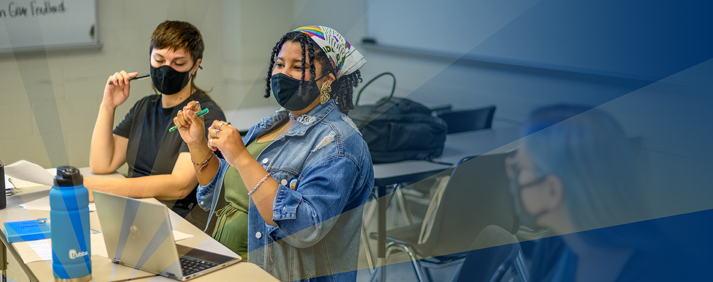 Three women in class talking